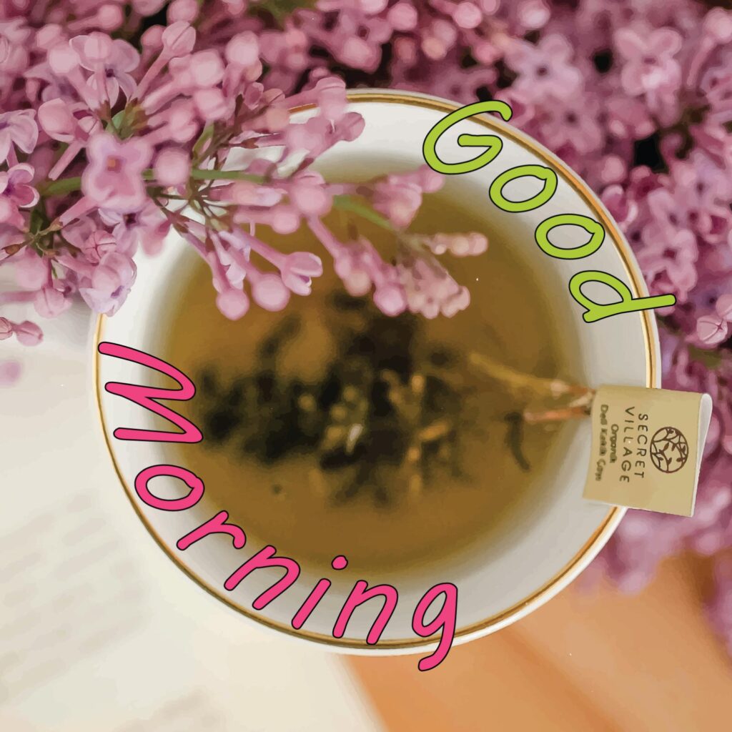 A tea cup with pink flowers and good morning written around it